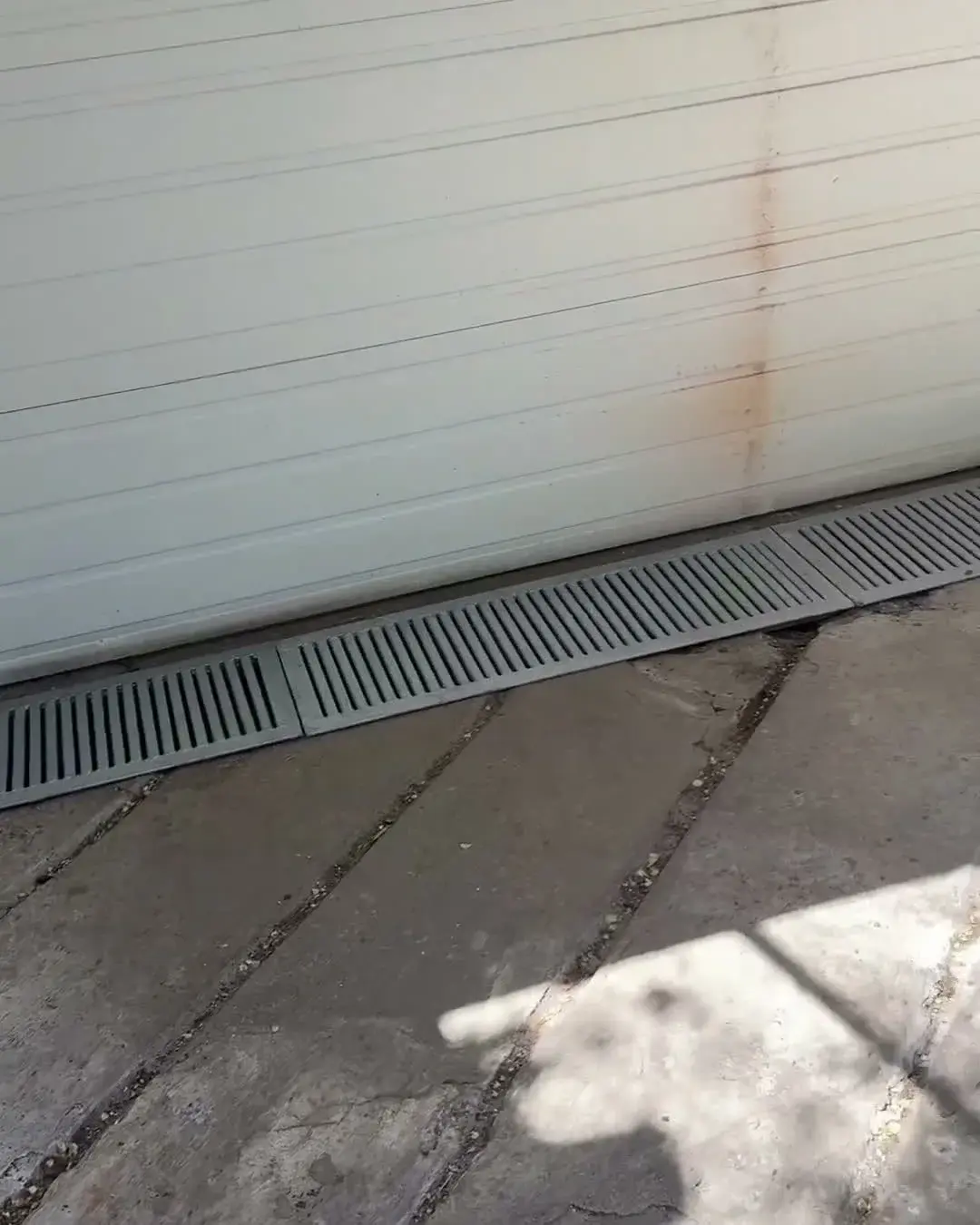Custom driveway & surface drainage grates flush-fit at the garage door line in The Beaches, Toronto, The Grate Guys